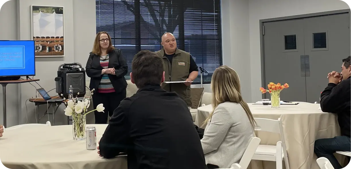 Group of event rental business owners discussing purchasing strategies at an industry association meeting