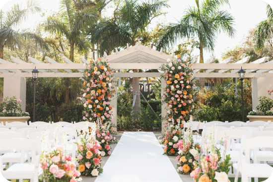 Inspiration station Coral and peach blooms frame a sun-drenched ceremony aisle at The Vinoy Resort in this event by Parties A La Carte