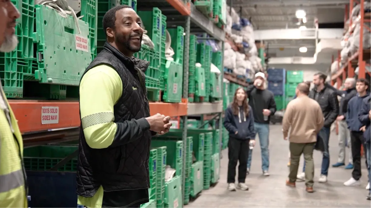 Interior of TGIF Tent & Party Rentals' warehouse showing vertical racking, labeled sidewall storage, and organized tent top bins